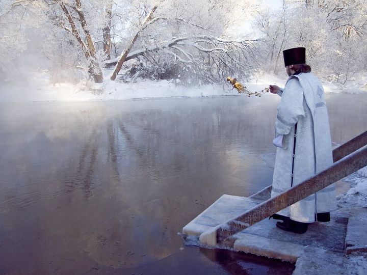 Священник освящает водоем